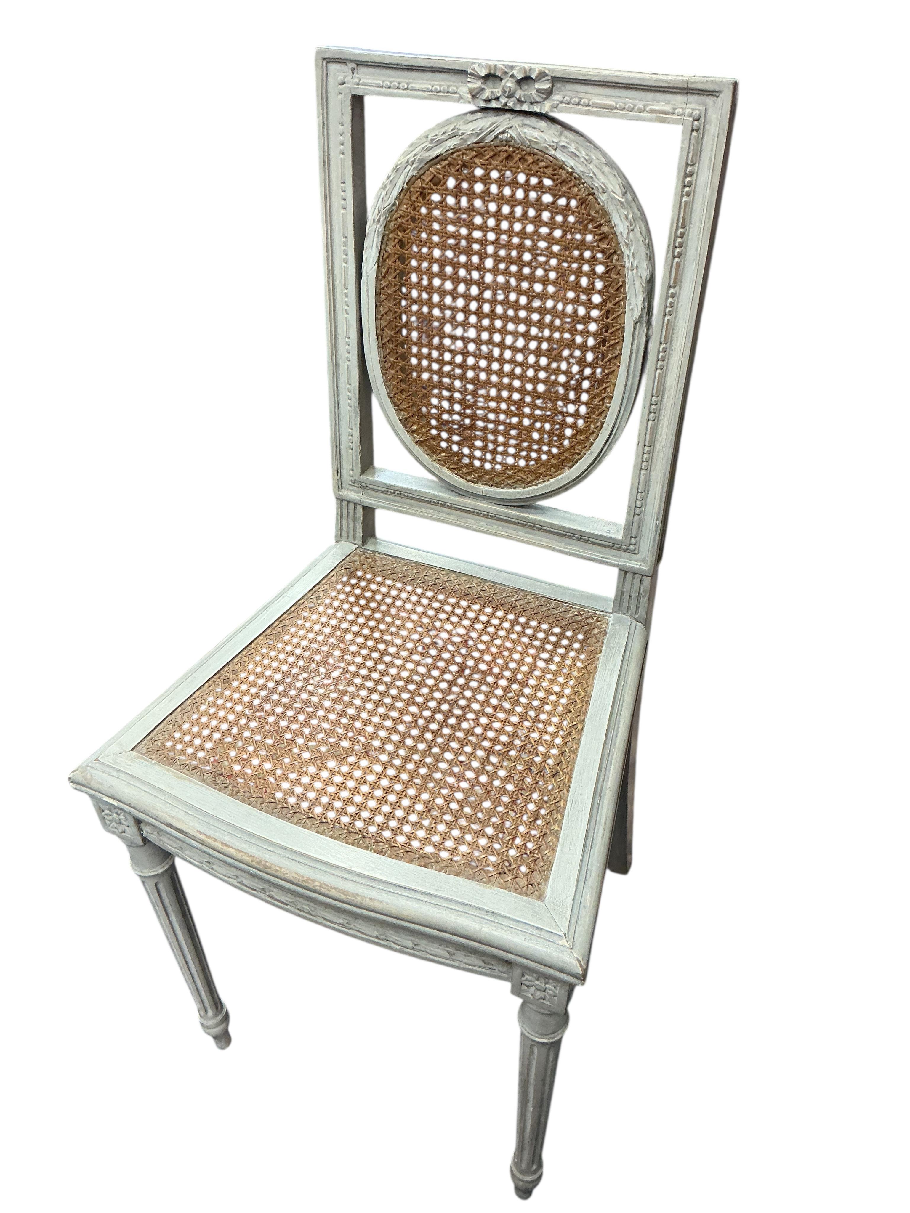 A pair of early 20th century French painted caned side chairs and one other chair